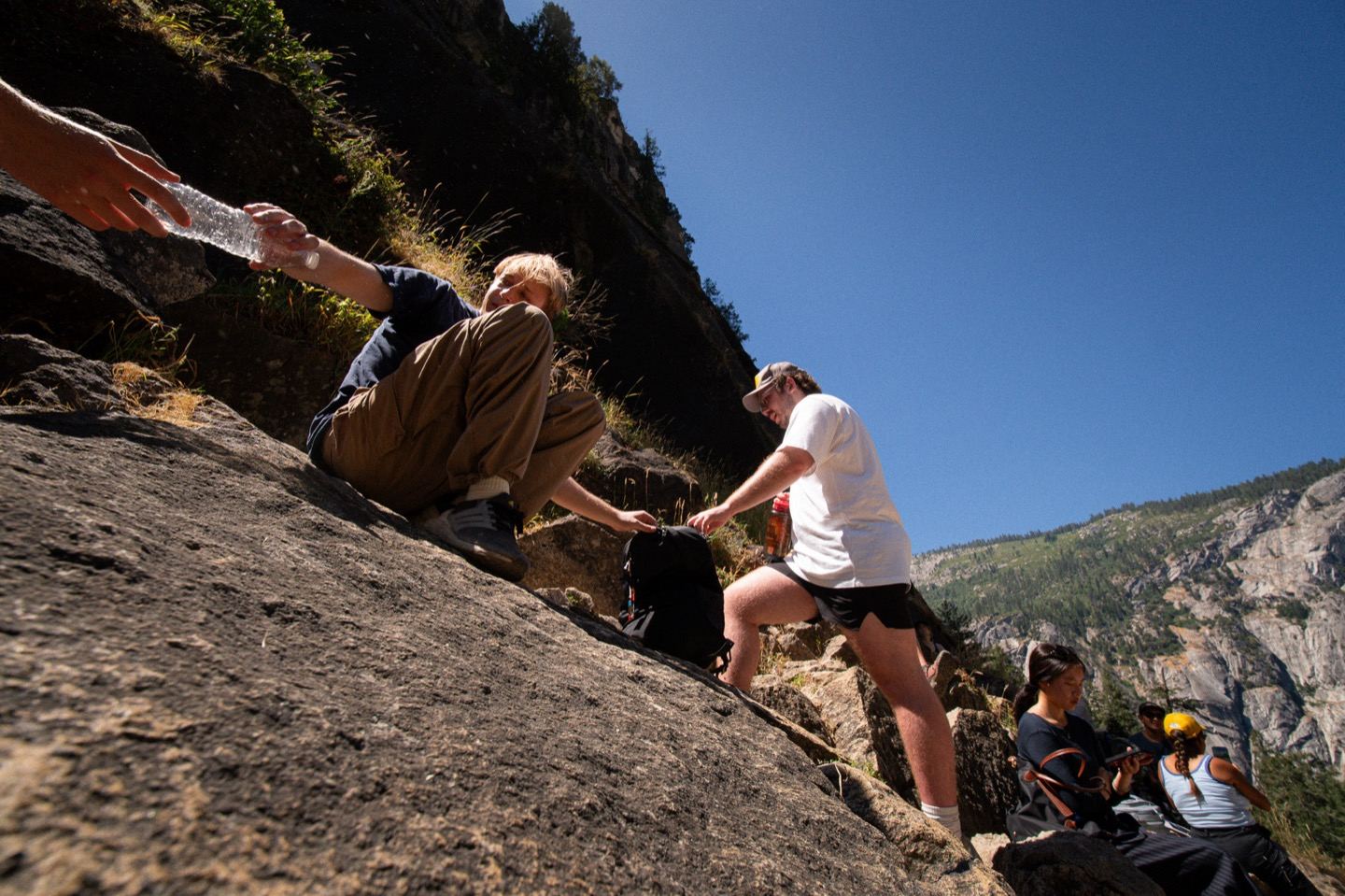 The team scrambling up a rocky trail on a valley hike